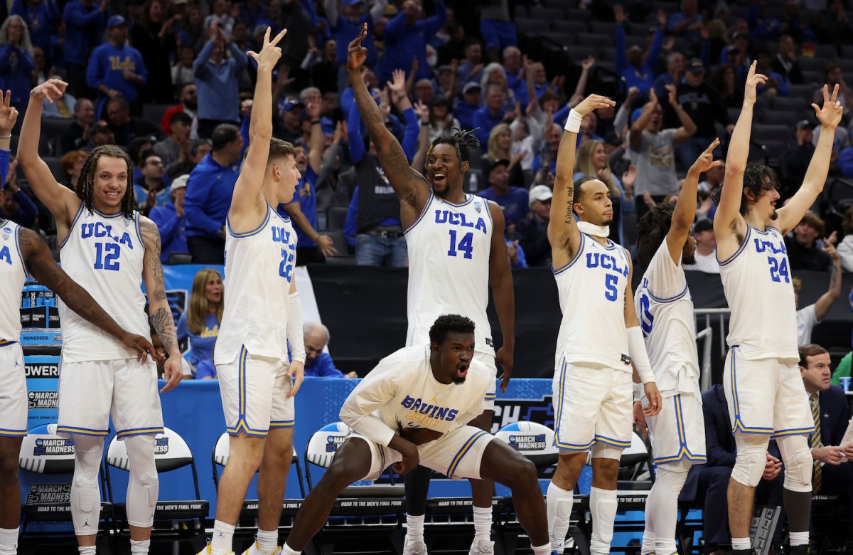 The UCLA Bruins celebrates a three point basket during the second half of a game against the North Carolina-Asheville Bulldogs in the first round of the NCAA Men's Basketball Tournament at Golden 1 Center on March 16, 2023 in Sacramento, California.