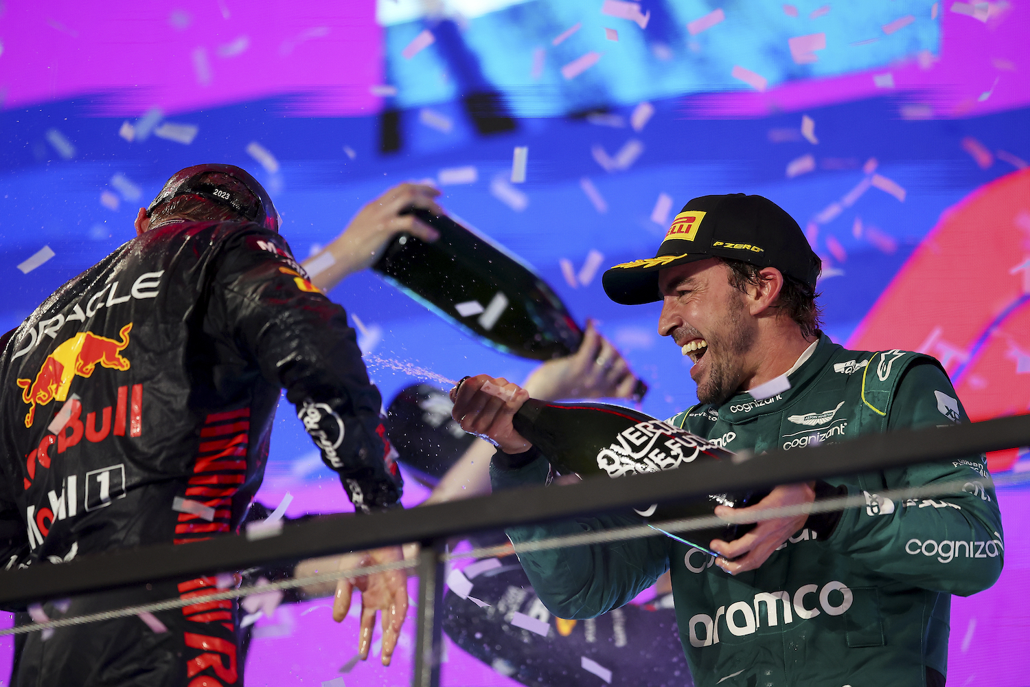 Second placed Max Verstappen of the Netherlands and Oracle Red Bull Racing and Third placed Fernando Alonso of Spain and Aston Martin F1 Team celebrate on the podium during the F1 Grand Prix of Saudi Arabia at Jeddah Corniche Circuit on March 19, 2023 in Jeddah, Saudi Arabia.