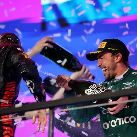Second placed Max Verstappen of the Netherlands and Oracle Red Bull Racing and Third placed Fernando Alonso of Spain and Aston Martin F1 Team celebrate on the podium during the F1 Grand Prix of Saudi Arabia at Jeddah Corniche Circuit on March 19, 2023 in Jeddah, Saudi Arabia.