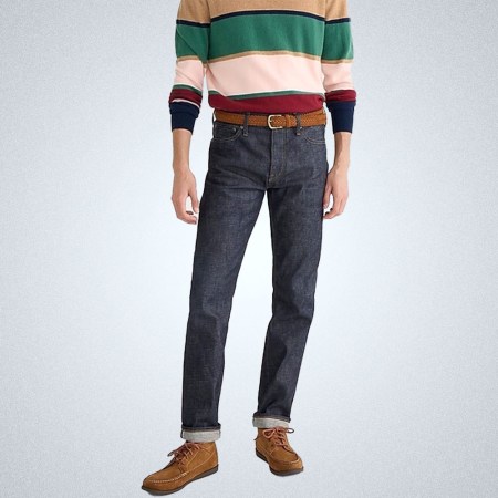 a model in a pair of dark wash J.Crew 770 Straight Fit Denim In Japanese Selvedge on a grey background