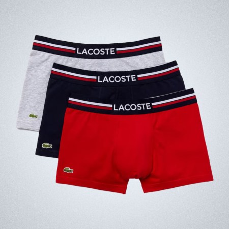 a trio of Lacoste Iconic Three-Pack Trunks on a grey background