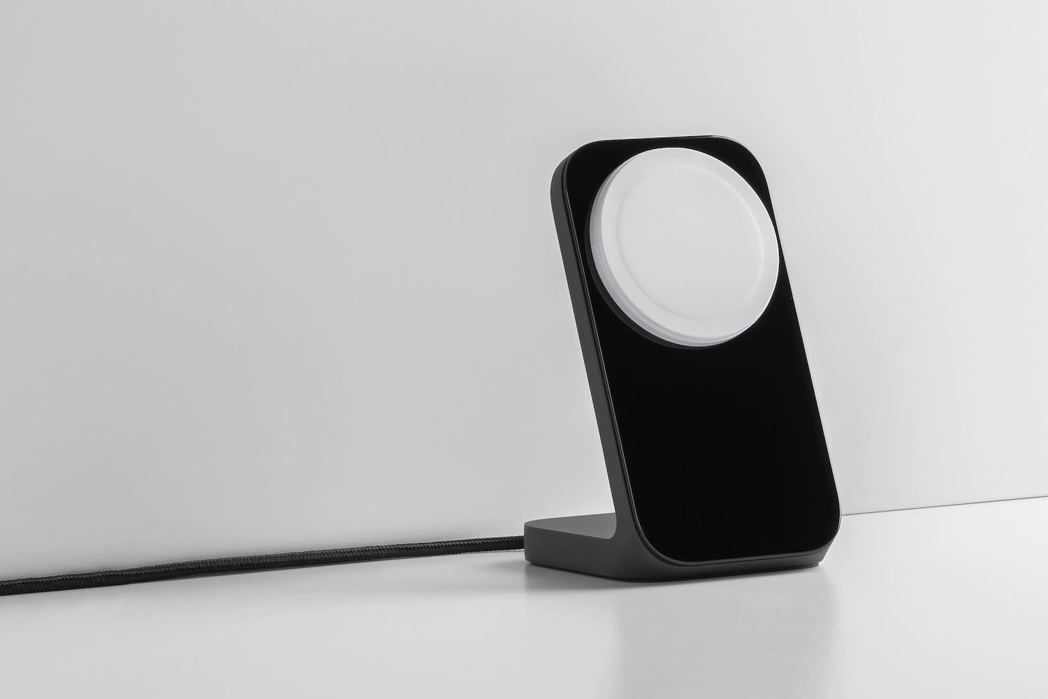 a Nomad Stand One Charger on a marble background