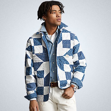 a model in a blue and white patchworked PRL jacket on a grey background