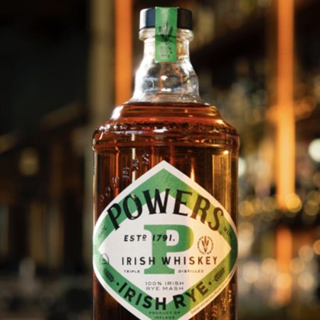 A close-up of a bottle of Powers Irish Rye, the first modern 100% Irish rye whiskey