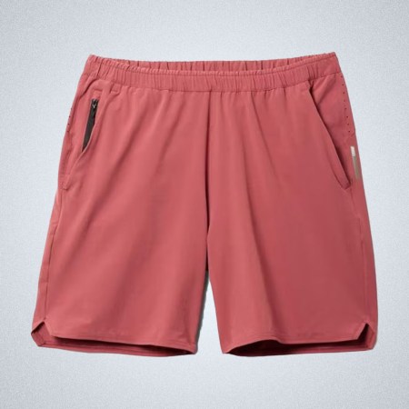 a pair of red REI Active Pursuit 7 Shorts on a grey background