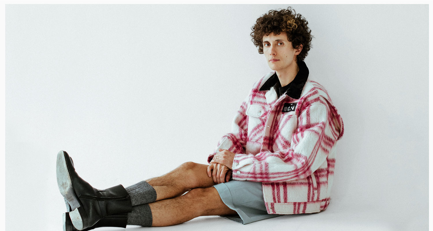 Ron Gallo wearing PHIPPS Chore Coat, Canali Shorts, and Squared Boots.