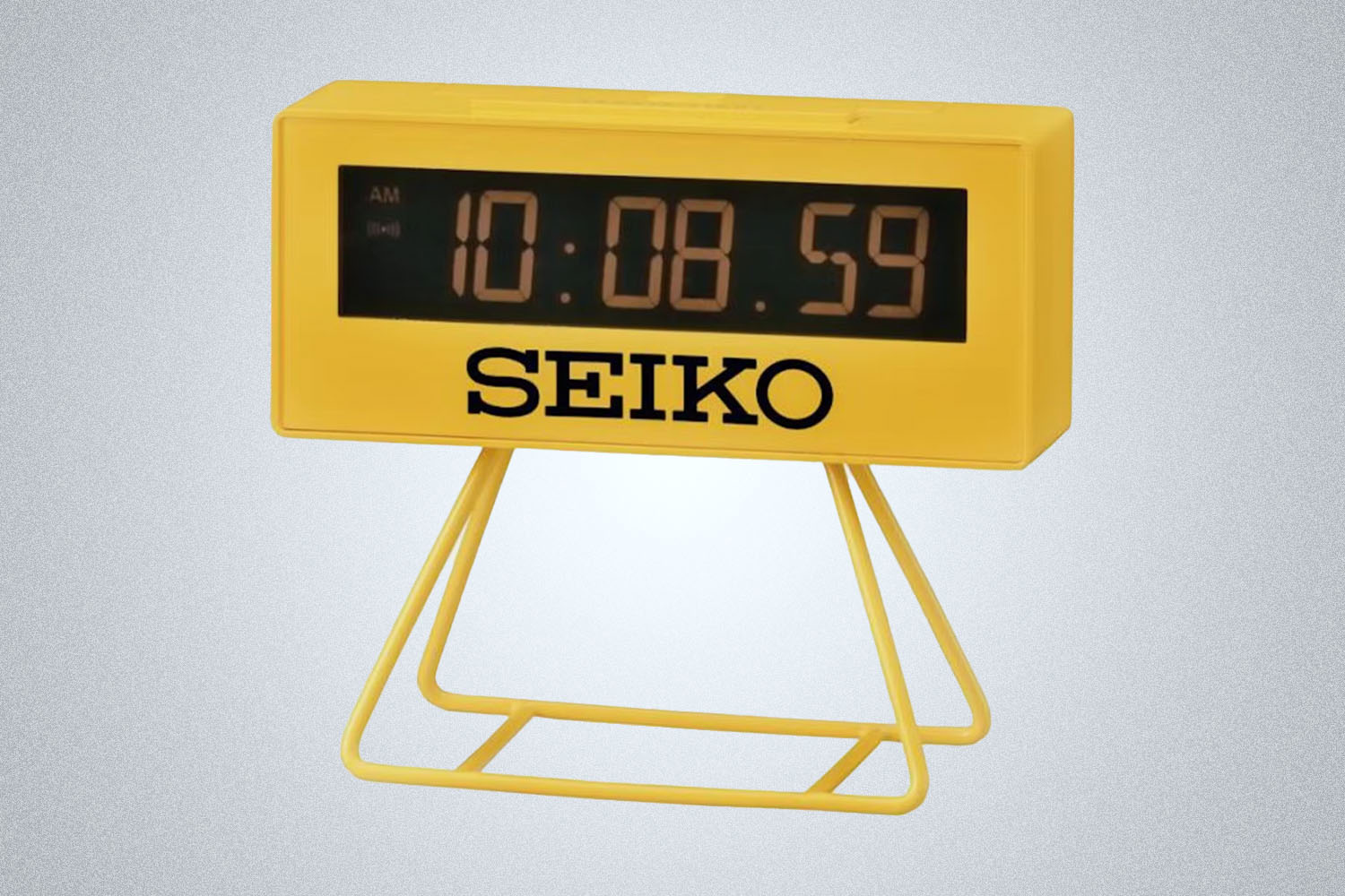 a yellow Seiko Olympia Digital Clock on a grey background