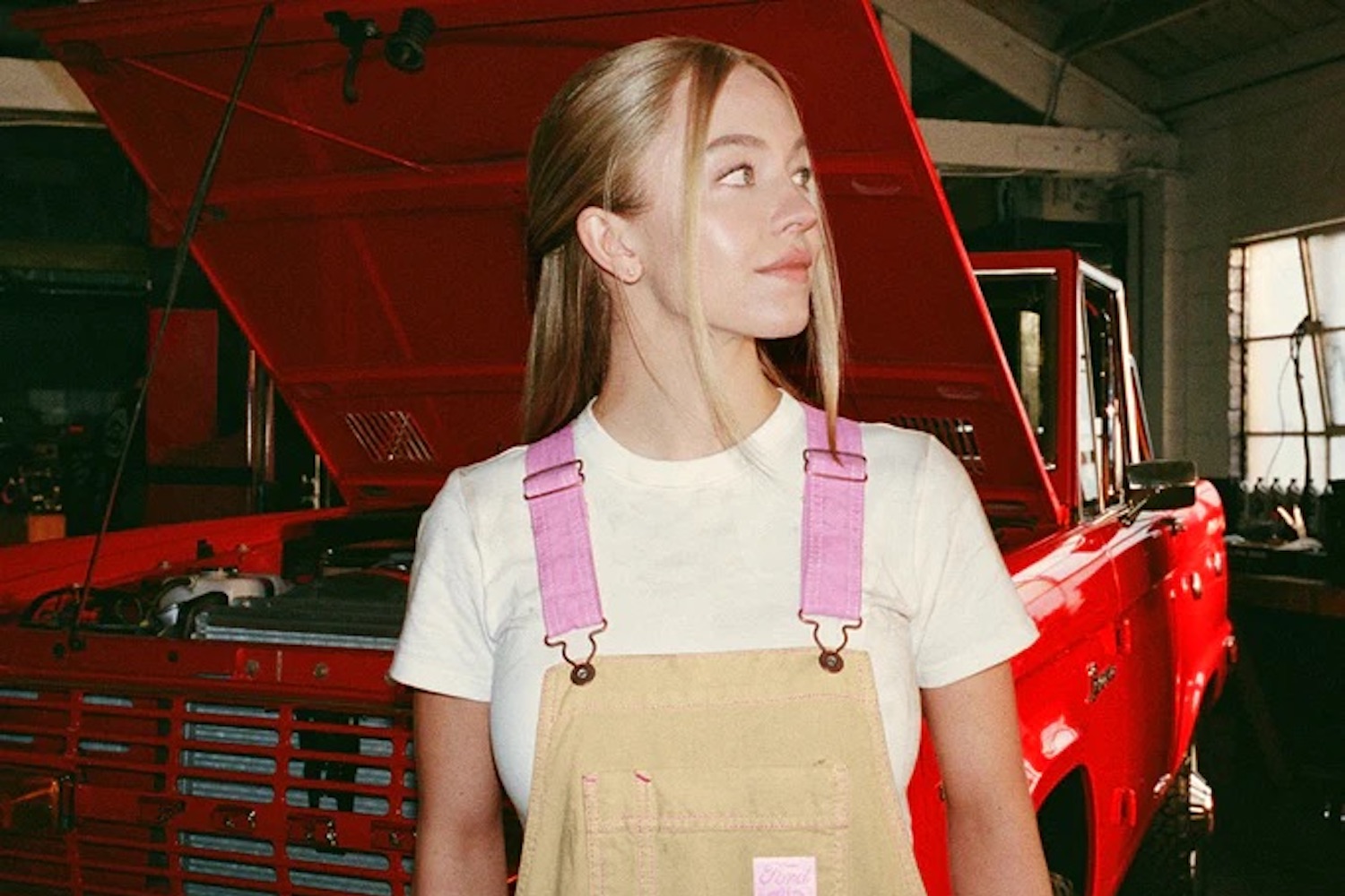 Sydney Sweeney in a pair of tan Ford x Sydney Sweeney overalls