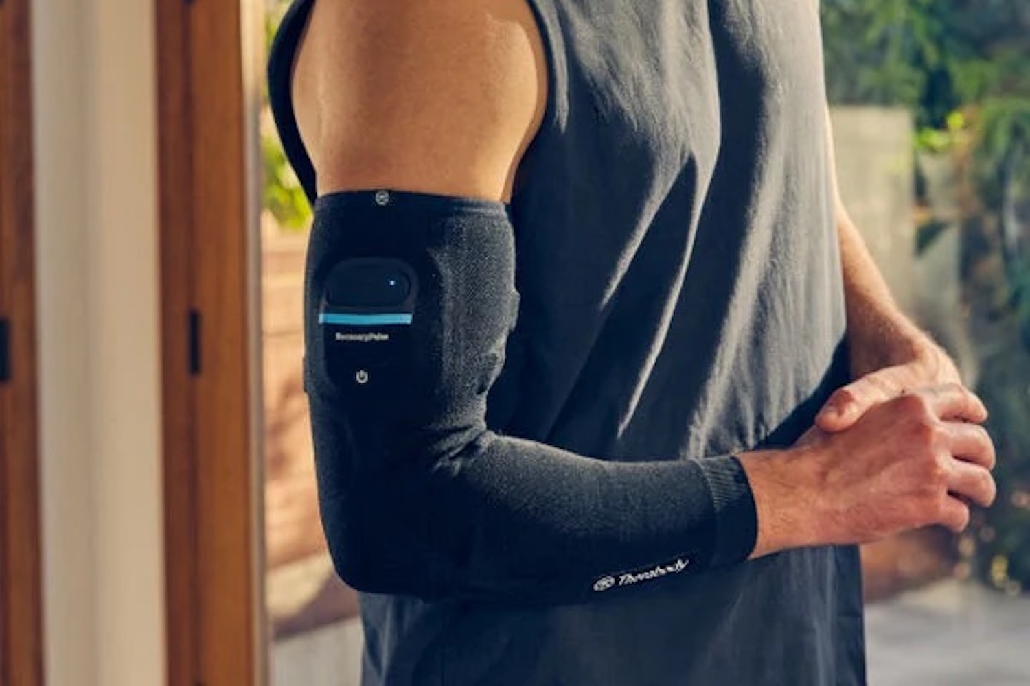a model in the new Therabody RecoveryPulse device