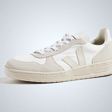 a pair of white Veja V-10 Sneakers on a grey background