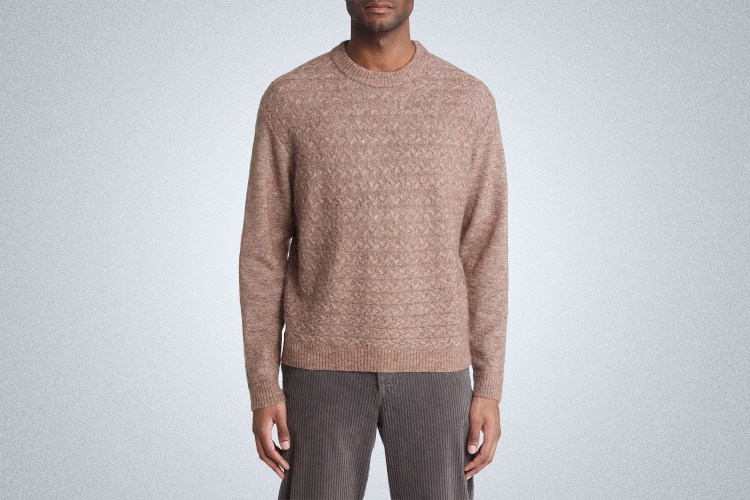 a model in a mauve wax london sweater on a grey background