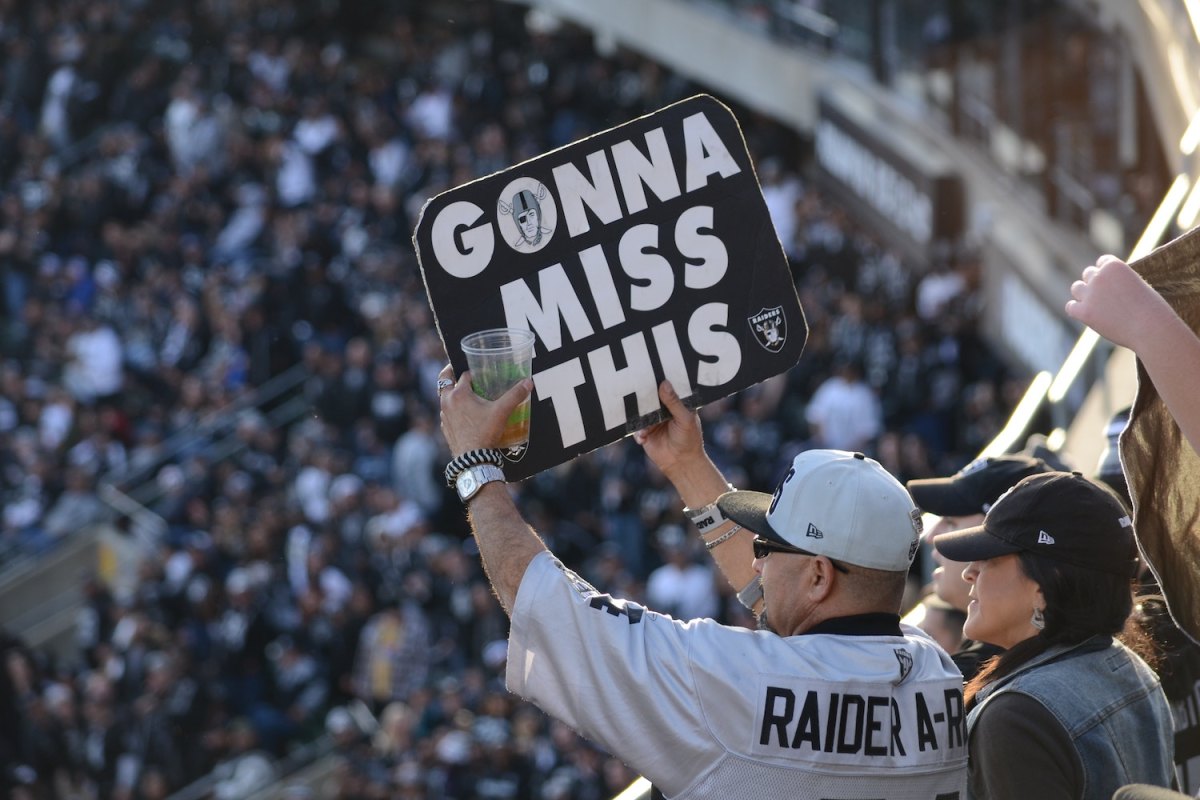 A Raiders football fan holds up a sign reading "Gonna Miss This" during the NFL team's final home game in Oakland, the year 2020.