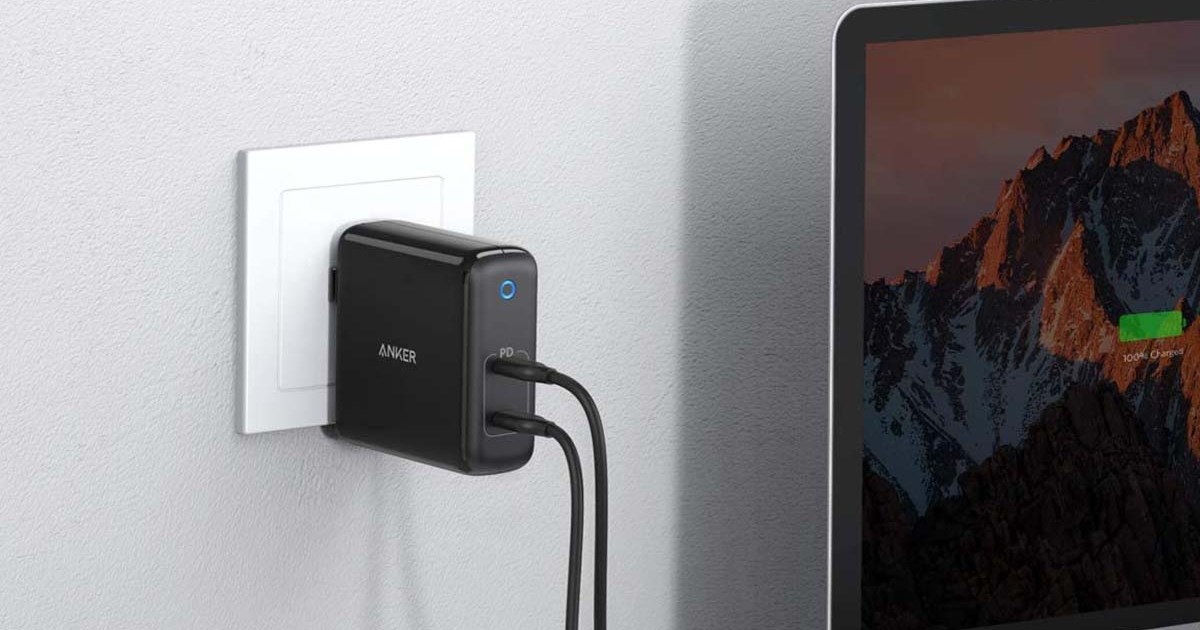 Anker's PowerPort Atom plugged into a wall and charging a laptop. Anker chargers are currently on sale at Amazon