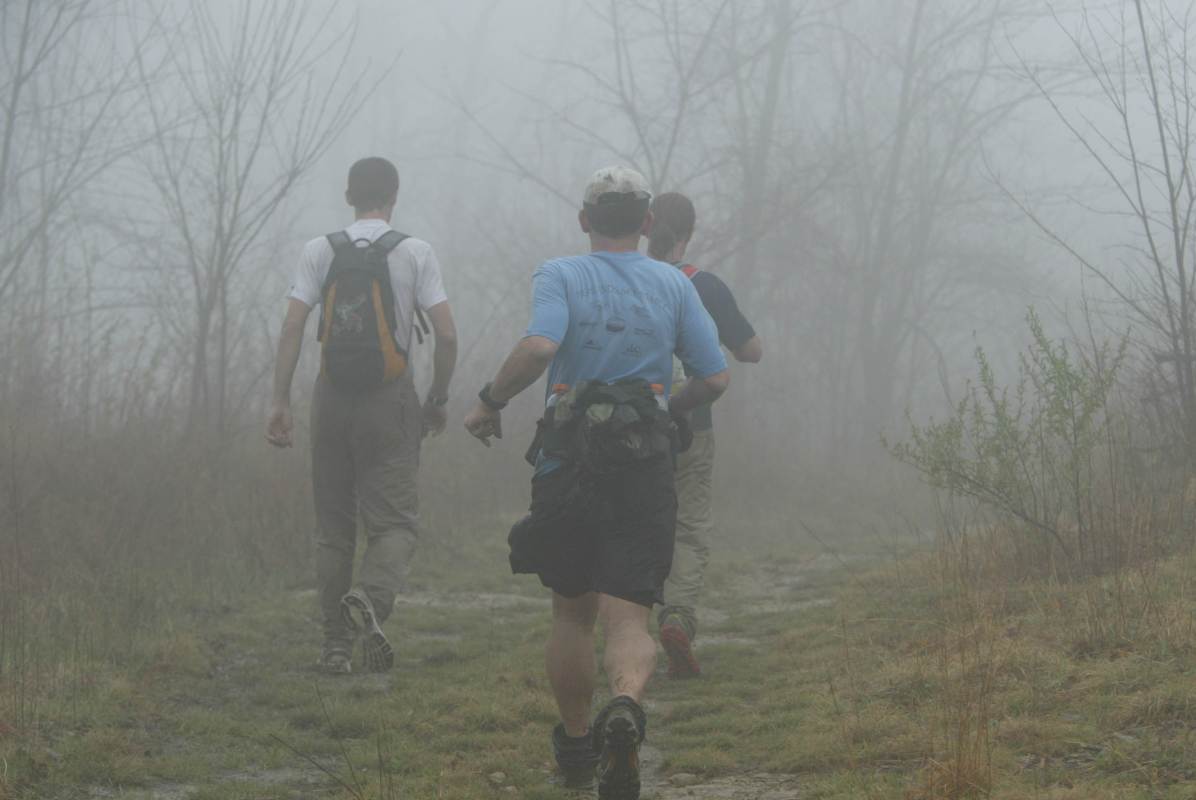 Three runners running into the fog at the Barkley Marathons.