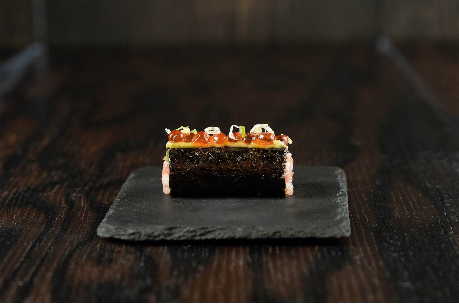 Blue Fin Tuna served inside a cylinder of crispy roll, topped with avocado mousse and house cured salmon caviar