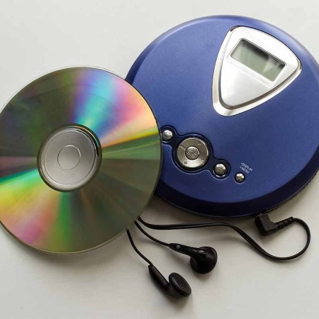 An old CD player with headphones isolated on white background. CDs launched in the U.S. on March 2, 1983, 40 years ago this week.