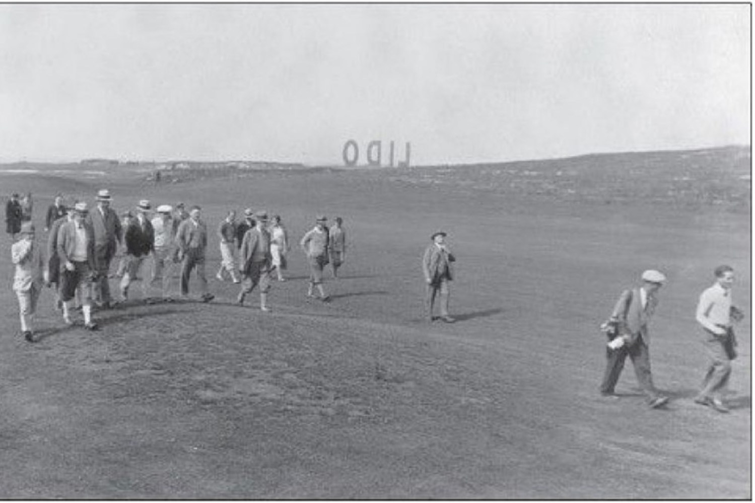 Photo of a match coming up the 17th fairway with a gallery. The LIDO sign in the background originally read LIDO BEACH like the Hollywood sign, but apparently the BEACH blew over at some point. It is backwards because it was facing Reynold's Channel and was an advertisement for the area’s housing developments. Golf Illustrated, August 1932.