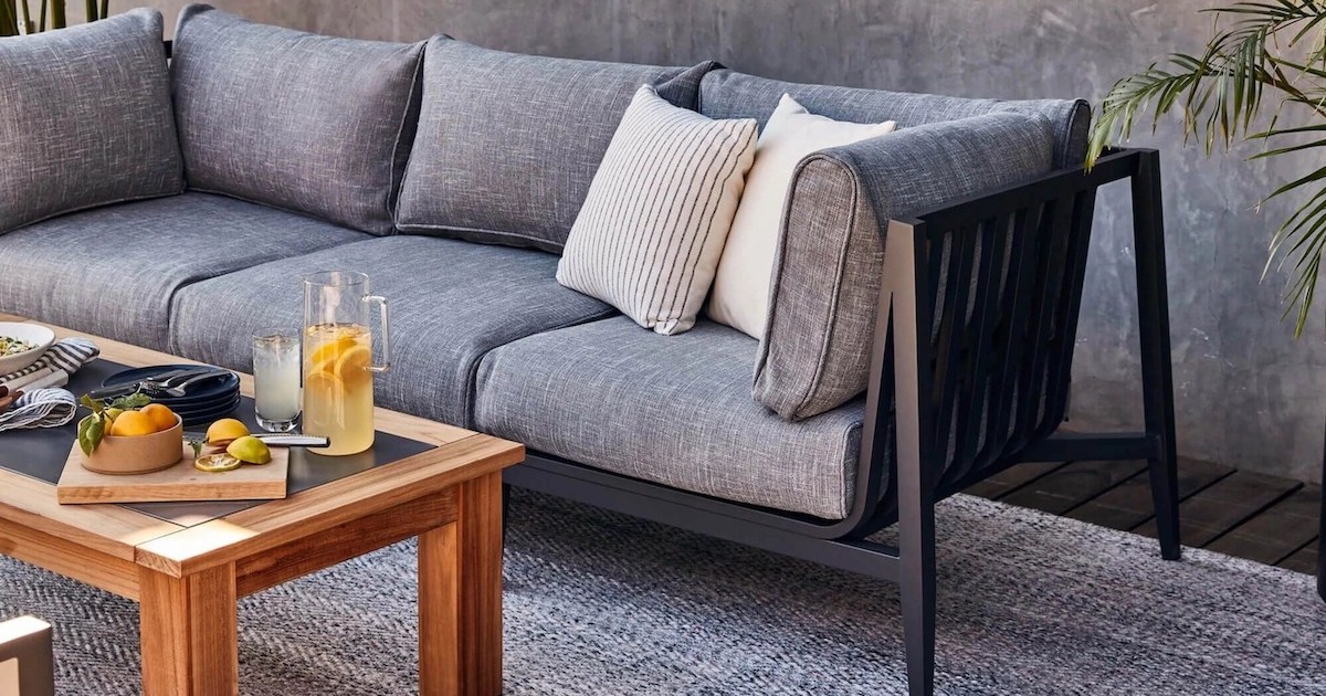 an grey Outer couch and wooden coffee table on a patio