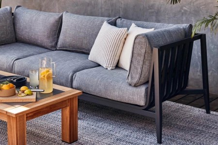 an grey Outer couch and wooden coffee table on a patio