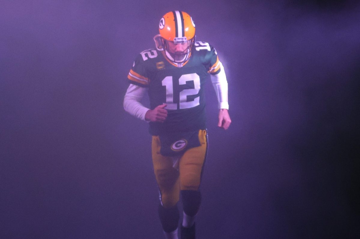 Aaron Rodgers takes the field for a game against the Detroit Lions.
