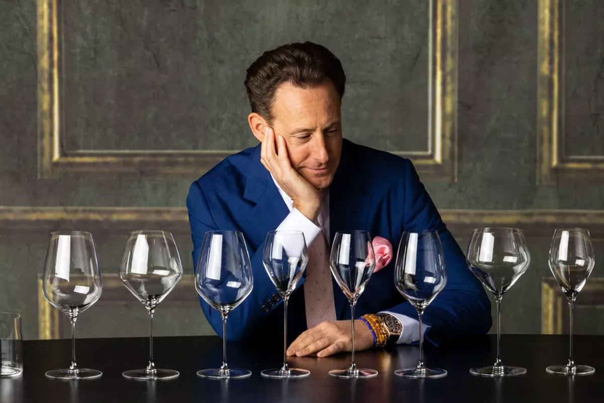 Head of Riedel Austrian glass manufacturer, Maximilian Riedel, tastes wine in his company's stand at Vinexpo wine fair in Bordeaux, southwestern France on May 13, 2019