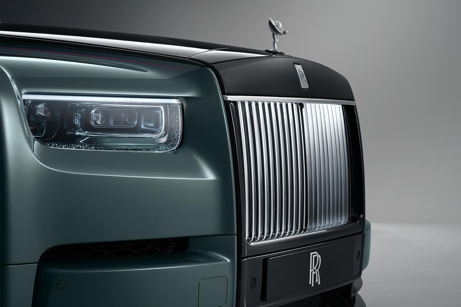 A close-up of the Rolls-Royce Phantom Series II grille and headlights with laser-cut starlight 