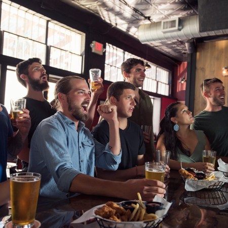 Group of friends watching game in bar