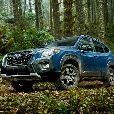 The 2022 Subaru Forester Wilderness in blue driving off-road