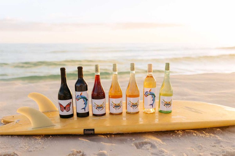 Tarpon Cellars lineup of wine on a surfboard
