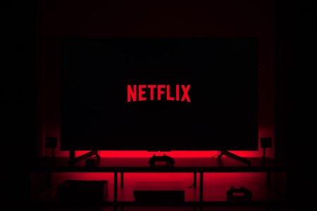Netflix cues up on a smart TV in a darkened room