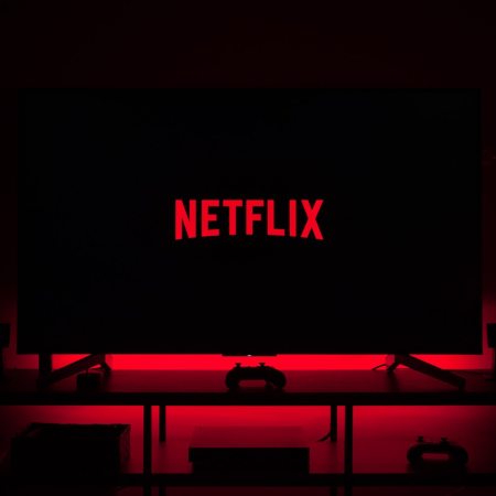 Netflix cues up on a smart TV in a darkened room