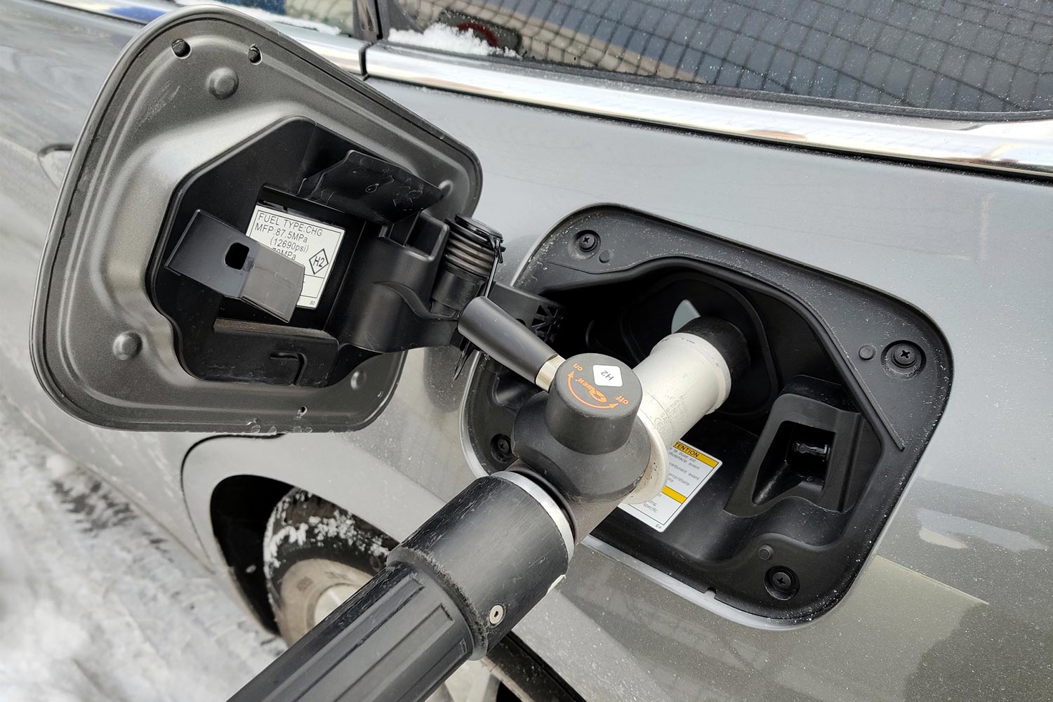 A hydrogen fueling nozzle connected to a port on the 2023 Toyota Mirai, which we tested and reviewed