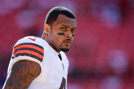 Deshaun Watson #4 of the Cleveland Browns looks on before the game against the Washington Commanders at FedExField on January 1, 2023 in Landover, Maryland. Watson, who at one time faced 20+ lawsuits regarding alleged sexual assault or harassment, is the QB for the team, which tried to honor International Women's Day.