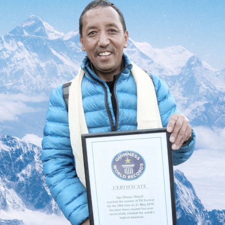 Apa Sherpa, a Nepalese climbing legend, holding his Guinness World Record plaque after achieving the record for the most summits of Mount Everest