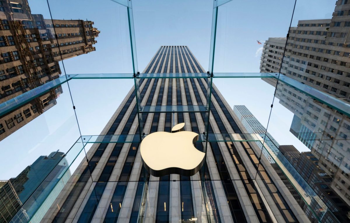 Apple logo on glass city building.