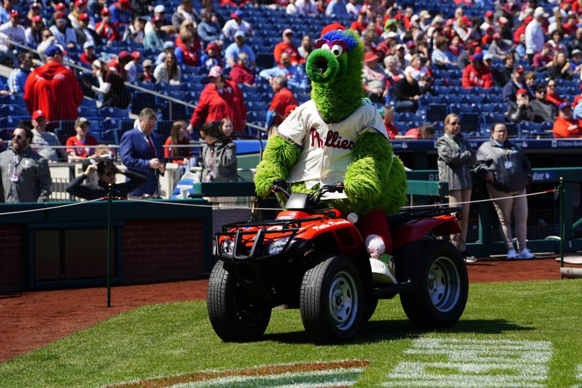 The Philly Phanatic rides around on a ride dirt bike on the baseball field