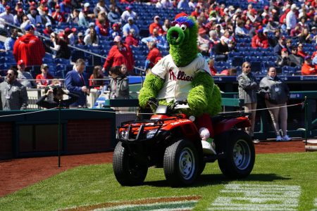 The Philly Phanatic rides around on a ride dirt bike on the baseball field