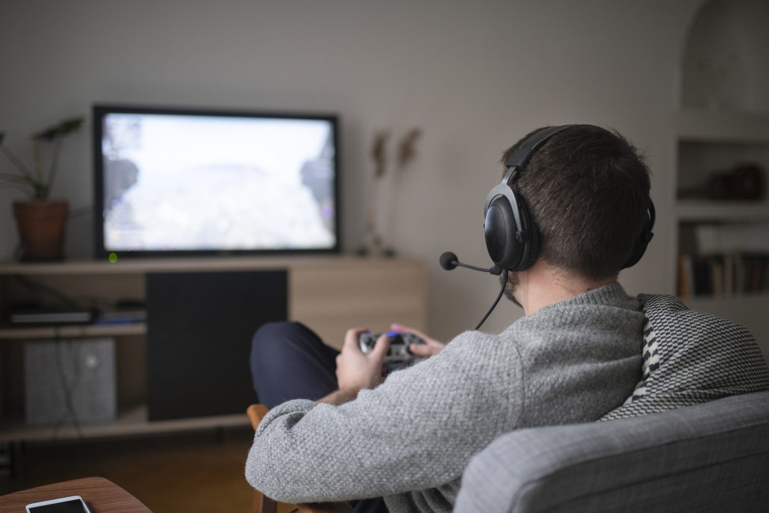 Man with headset playing video game