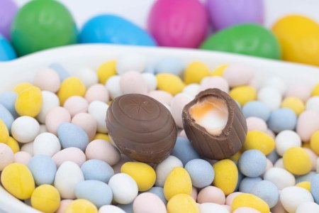 two Cadbury creme eggs on top of candy eggs