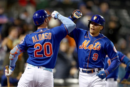 Pete Alonso #20 of the New York Mets congratulates teammate Brandon Nimmo #9 after Nimmo hit a solo home run in the first inning against the Washington Nationals during game two of a double header at Citi Field on October 04, 2022 in the Flushing neighborhood of the Queens borough of New York City.