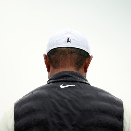Tiger Woods of the United States looks on from the 18th green during the continuation of the weather delayed second round of the 2023 Masters Tournament at Augusta National Golf Club on April 08, 2023 in Augusta, Georgia.
