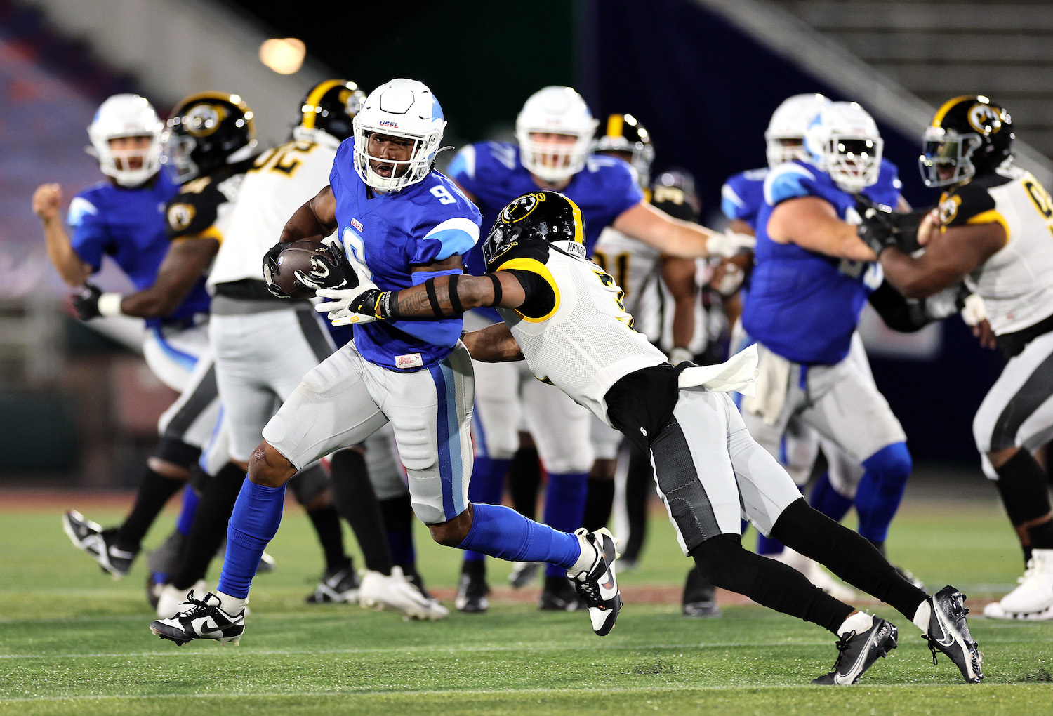 Wide receiver Jonathan Adams #9 of the New Orleans Breakers carries the ball as safety Eli Walker #3 of the Pittsburgh Maulers defends during the game at Protective Stadium on April 16, 2023 in Birmingham, Alabama.