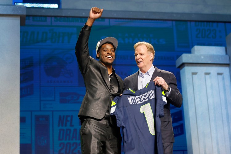 Devon Witherspoon poses with NFL Commissioner Roger Goodell after being selected fifth overall by the Seattle Seahawks during the first round of the 2023 NFL Draft at Union Station on April 27, 2023 in Kansas City, Missouri.