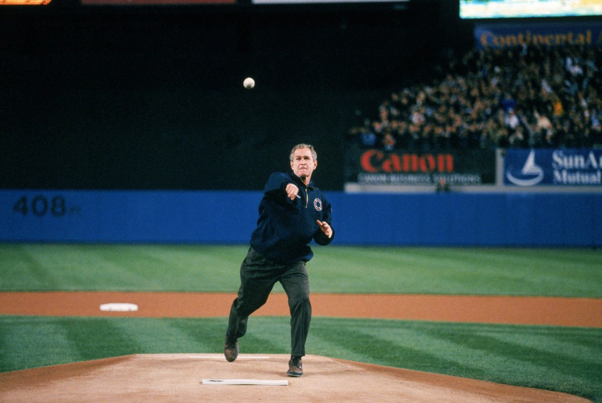 President George W. Bush throws out the ceremonial first pitch before Game Three of the 2001 World Series between the Arizona Diamondbacks and the New York Yankees at Yankee Stadium on October 30, 2001 in Bronx, New York.