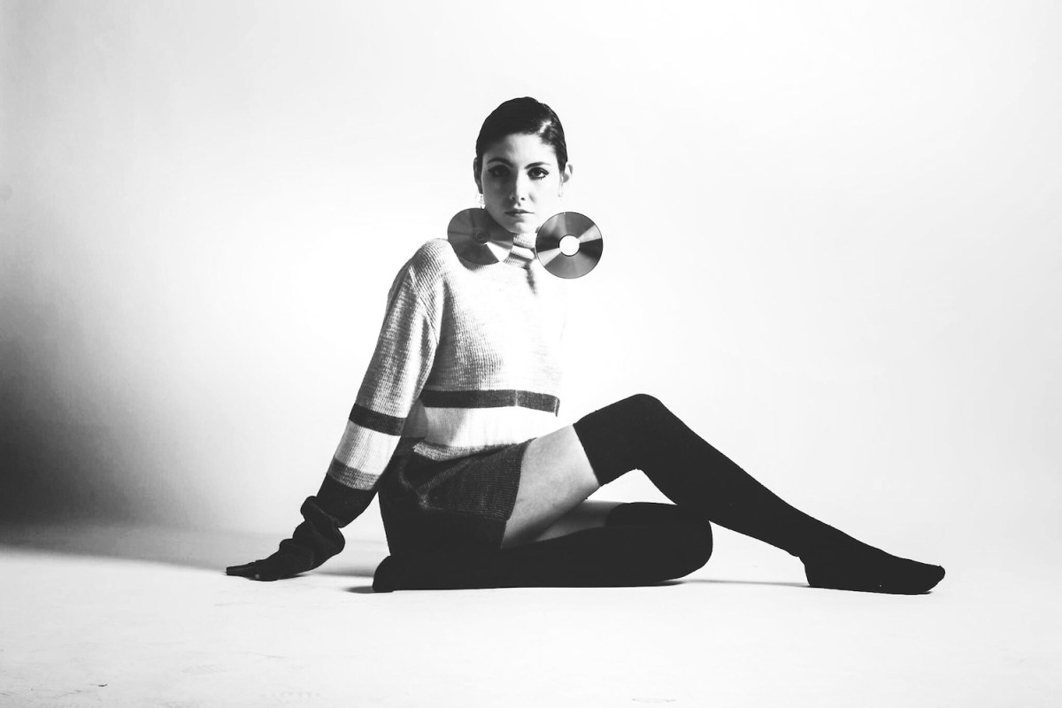 black and white Studio Shot Of Woman In Mod Clothing and mini skirt