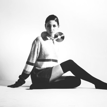 black and white Studio Shot Of Woman In Mod Clothing and mini skirt