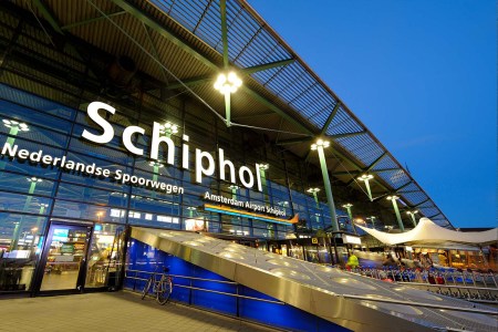 The entrance of Amsterdam Airport Schiphol in the evening.