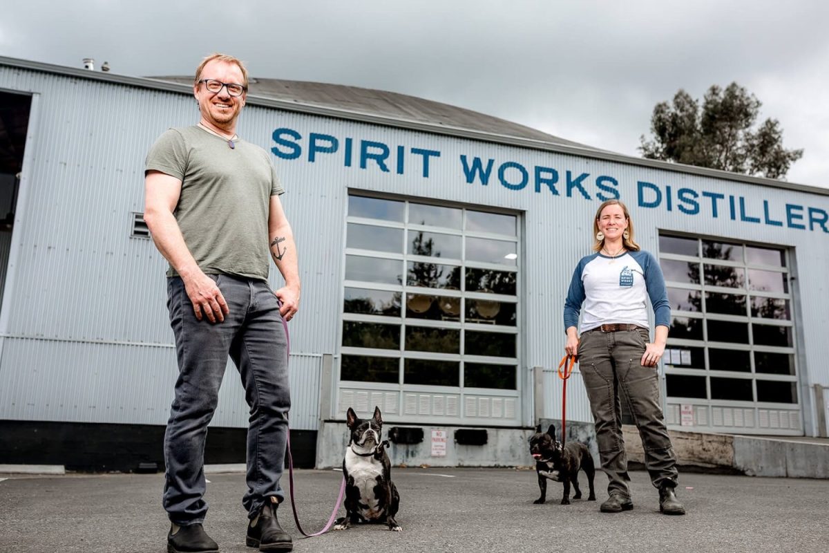 The couple who founded Spirit Works outside of their establishment with their dogs.