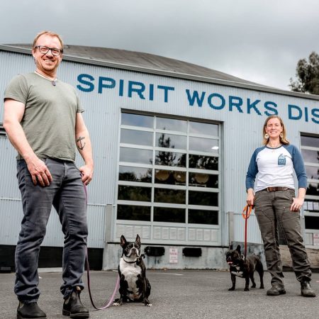 The couple who founded Spirit Works outside of their establishment with their dogs.