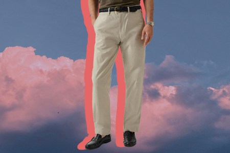 a model in a pair of travel pants on a cloud background